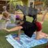 Erica McMillan of Honolulu practicing yoga while surrounded by playful goats at the DLT Stables with Bmax Fitness in Waimanalo. Honolulu Vibes Photo - Ronen Zilberman